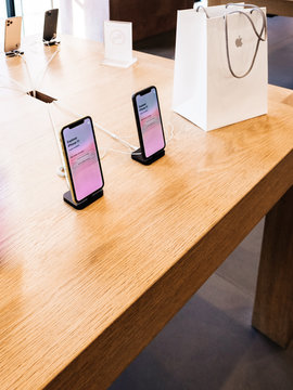 Paris, France - Sep 20, 2019: View From Above Of New IPhone 11 Displayed In Apple Store As They Goes On Sale - White Present Shopping Bag On Wooden Table Corner