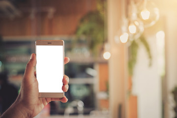 The hand is holding the phone with a white telephone screen