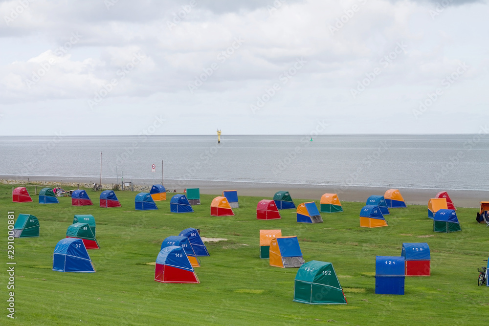 Wall mural Colorful wooden beach chairs at the Dike of the North Sea in Otterndorf, Germany