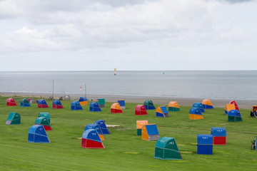Colorful wooden beach chairs at the Dike of the North Sea in Otterndorf, Germany