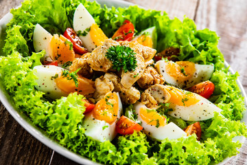 Boiled eggs with roast chicken fillet and vegetables