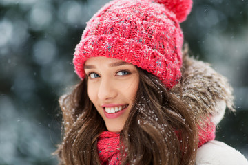 people, season and christmas concept - portrait of happy smiling teenage girl or young woman outdoors in winter park