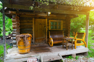 The veranda of a small wooden bathhouse on the porch of which there are benches and a large old bath. Rest and health in nature.
