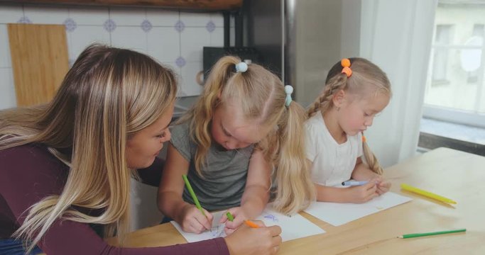 Mother and daughters paint together