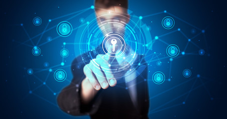 Man touching hologram screen displaying keys and locks