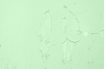 Texture of cracked wall background toned green mint. Old cracked background.