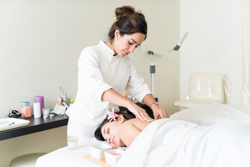 Therapist Pampering Woman With Relaxing Back Rub