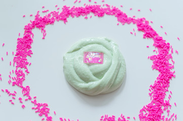 hand made toy called slime. green slime and pink sprinkles. 