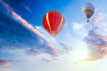 Balloons fly against the background of sunset . Hot air balloons