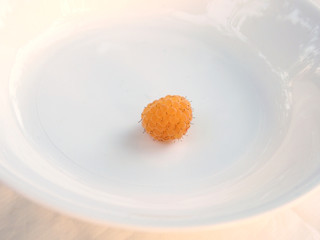 Ripe yellow raspberry on a white plate