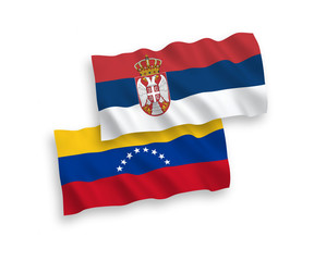 National vector fabric wave flags of Venezuela and Serbia isolated on white background. 1 to 2 proportion.