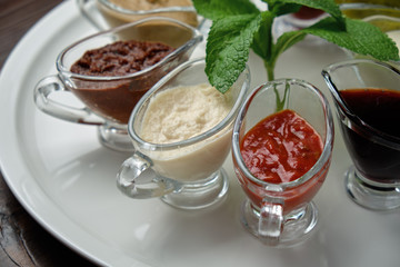 sauces in bowls on a dark wooden background. menu for catering