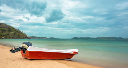 Orange color motor boat at Marble beach in Trincomalee, Sri Lanka
