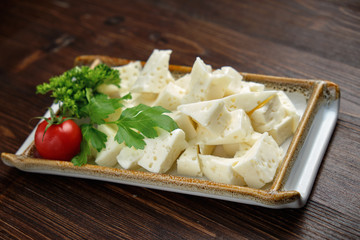 Cheese platter on a dark background. Food styling. Restaurant menu