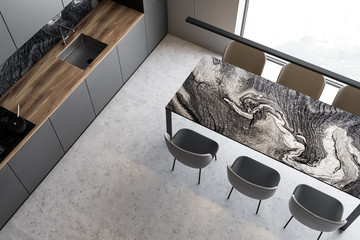 Top view of gray kitchen with marble table