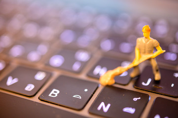 Miniature Worker model cleaning computer's dirty keyboard for hygenic, medical, clean purpose