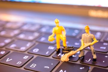 Miniature Worker model cleaning computer's dirty keyboard for hygenic, medical, clean purpose