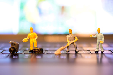 Miniature Worker model cleaning computer's dirty keyboard for hygenic, medical, clean purpose