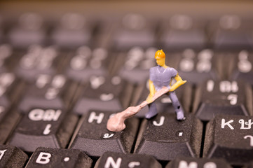 Miniature Worker model cleaning computer's dirty keyboard for hygenic, medical, clean purpose