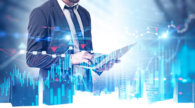 Businessman with laptop in city, forex charts