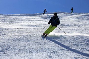 Sporty skier riding the slope 