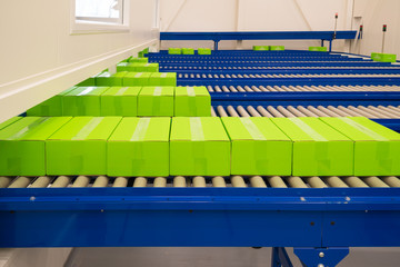 conveyor belt with green boxes