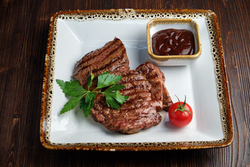 Steak on the bone with red sauce. restaurant menu
