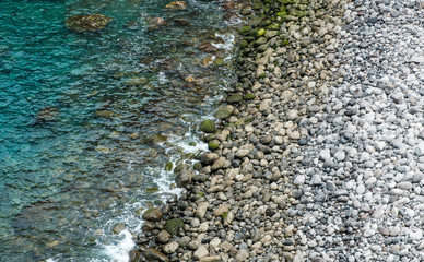stone beach, pebble stones on ocean coast