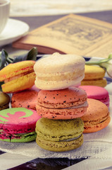 Sweet and colorful macarons. Closeup macaroons on a plate. Tasty french delicate dessert for breakfast. Vintage tone style.