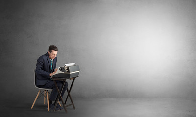Man working hard on a typewriter in an empty space