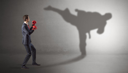 Businessman fighting with his strong karate man shadow © ra2 studio