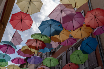 Fototapeta na wymiar Street decorated colorful umbrellas outdoor background