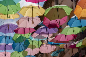 Fototapeta na wymiar background with colored umbrellas on one street