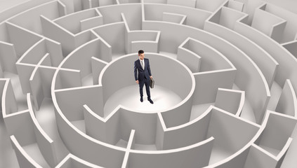 Young businessman standing in a middle of a 3d round maze