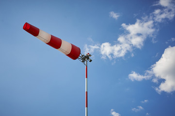 Windsock blown by the wind with overcast sky