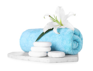 Composition with towel, spa stones and fresh flower isolated on white