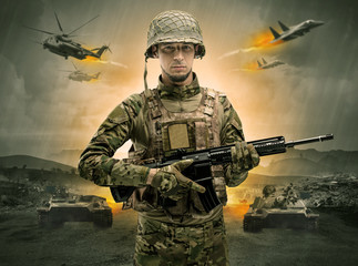 Armed soldier with sniper in the middle of a war