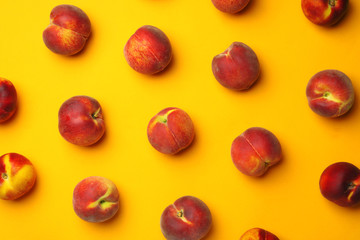 Flat lay composition with ripe peaches on orange background