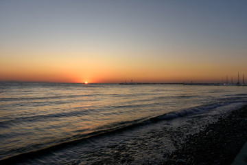 Fototapeta premium A fishing boat on the background of the morning sunset