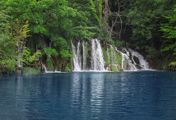 Fototapeta premium Picturesque view of beautiful waterfall and river