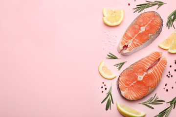 Flat lay composition with salmon steaks on pink background. Space for text