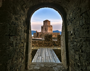 Entrance to wooden bridge and impressive three-tiered fortified watchtower. Venetian fort castle of...