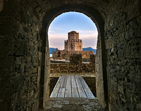 Entrance to wooden bridge and impressive three-tiered fortified watchtower. Venetian fort castle of Methoni, Peloponnese,  Greece.
