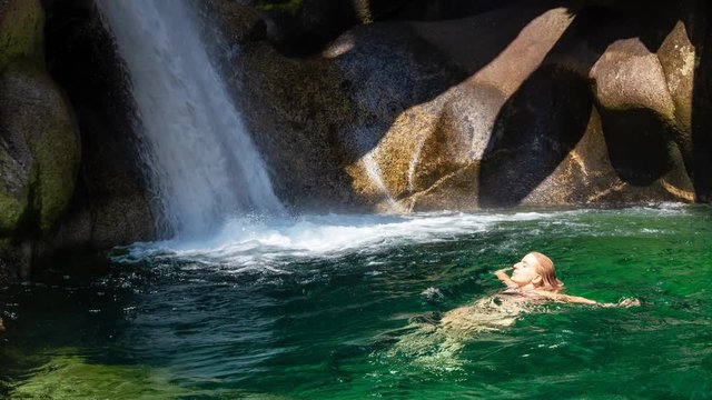 Cinemagraph of a Woman enjoying a swim in the glacier river running down the beautiful Canadian canyon. Taken in Squamish, North of Vancouver, BC, Canada. Still Image Continuous Loop Animation