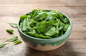 Fresh green healthy spinach on wooden table