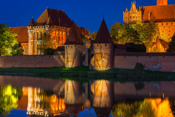Malbork castle over the Nogat river at night, Poland