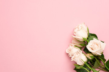 Fototapeta na wymiar Beautiful white roses flower on pink background with copy space for your text