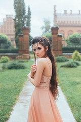 Portrait of a sad, lonely, scared princess who stands frozen and wet in the pouring rain....