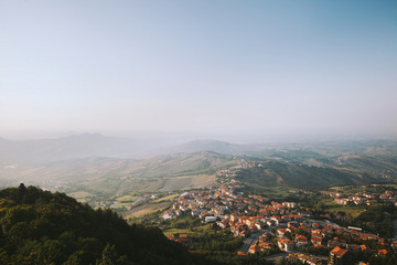 View from the top of San Marino castle. San Marino suburban districts and Italian hills view from above. Panorama of San Marino and Italy from Monte Titano.