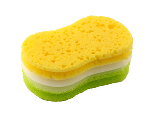 Yellow and green sponge for washing dishes on a white background. The sponge has a knurled surface. It can be used for household and car wash.
